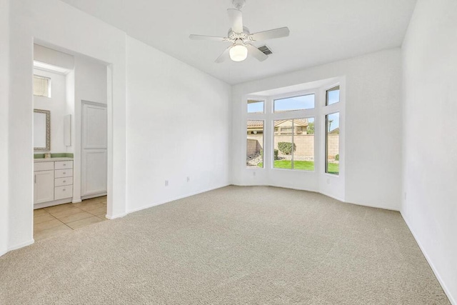 unfurnished room featuring ceiling fan and light carpet