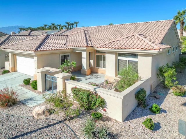 view of front of home with a mountain view and a garage