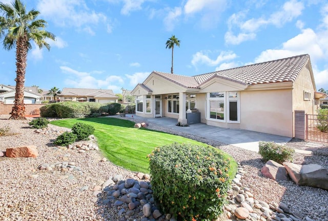 back of house featuring a yard and a patio