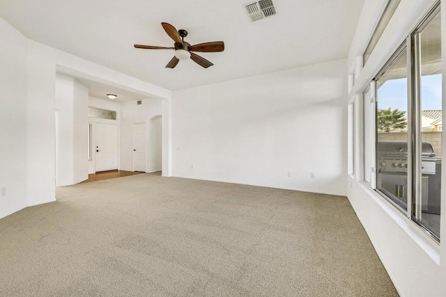 empty room featuring ceiling fan and carpet floors