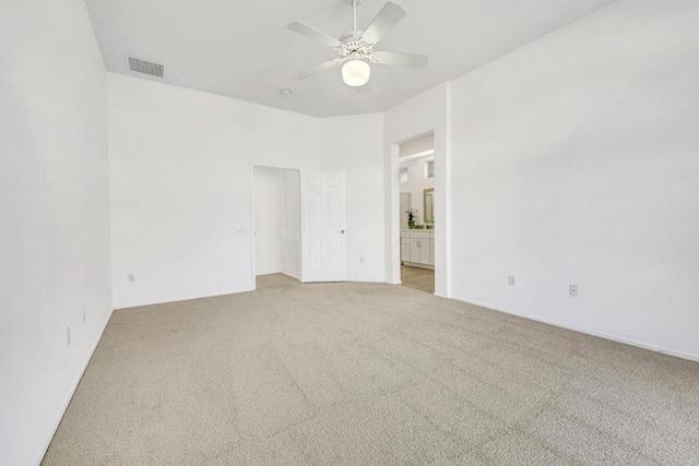 carpeted empty room featuring ceiling fan