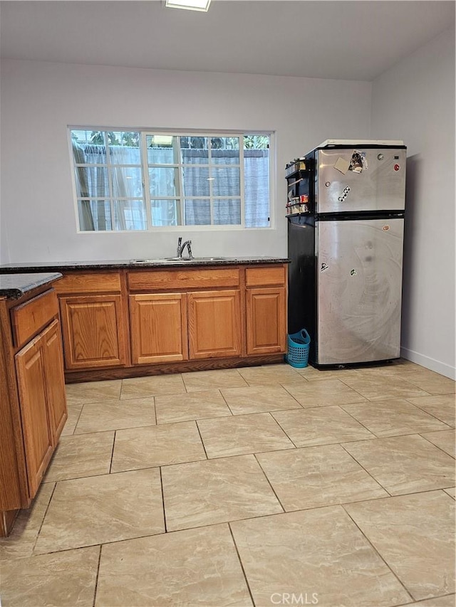 kitchen featuring stainless steel refrigerator and sink