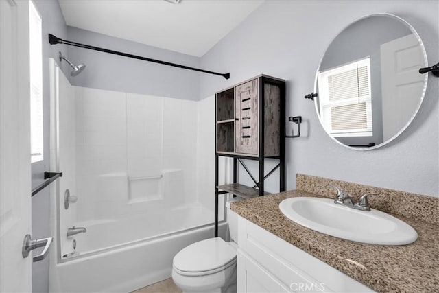 full bathroom with washtub / shower combination, vanity, toilet, and a wealth of natural light