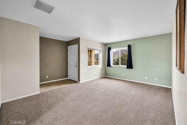 unfurnished room featuring light colored carpet