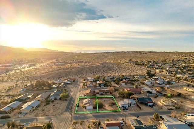 aerial view at dusk featuring a mountain view