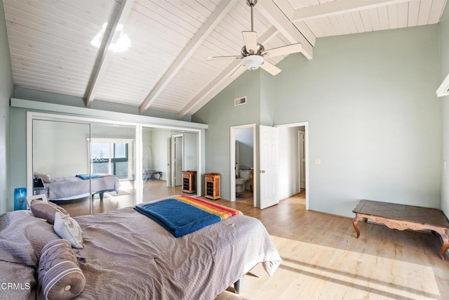 bedroom with beam ceiling, ceiling fan, light hardwood / wood-style flooring, and high vaulted ceiling