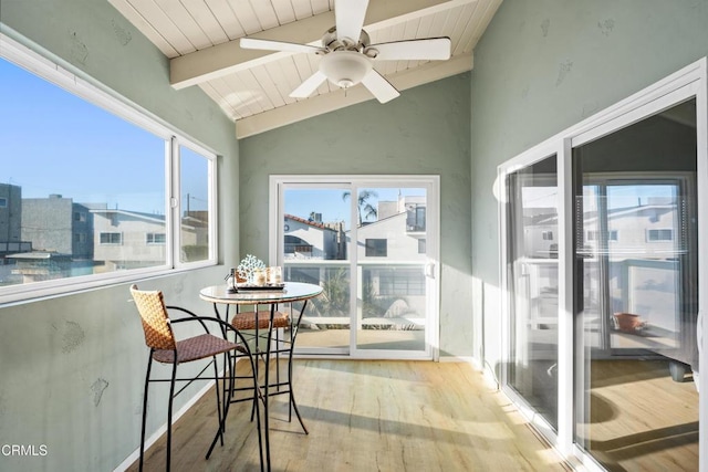 sunroom / solarium with ceiling fan, a water view, lofted ceiling with beams, and wooden ceiling