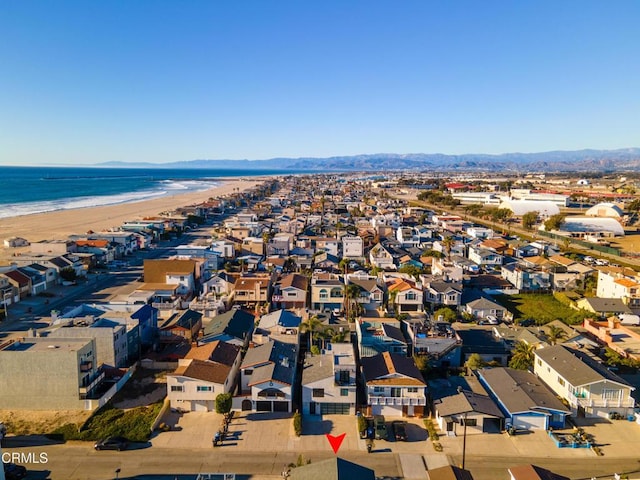 aerial view with a water view and a beach view