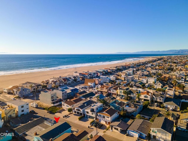 bird's eye view with a water view and a beach view