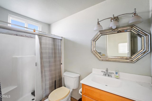 bathroom with vanity, toilet, and walk in shower