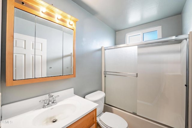 full bathroom featuring vanity, toilet, and bath / shower combo with glass door