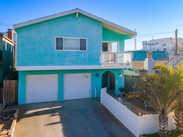 view of front of house featuring a balcony and a garage