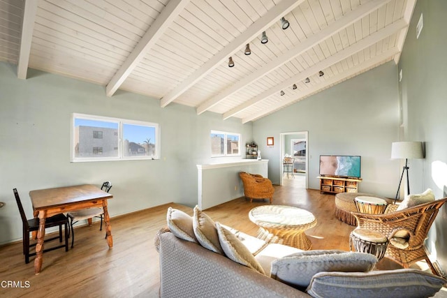 living room with vaulted ceiling with beams and hardwood / wood-style floors