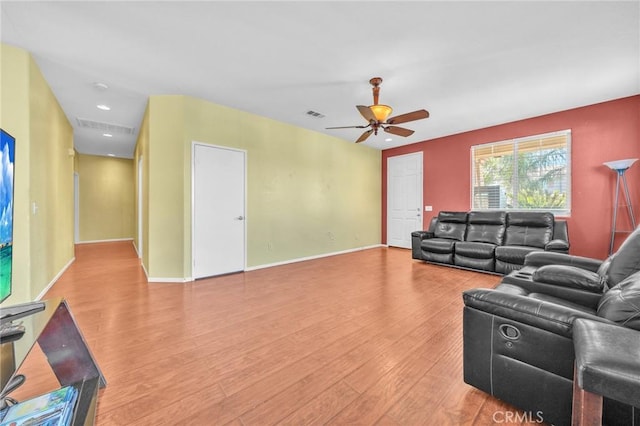 living room with hardwood / wood-style floors and ceiling fan