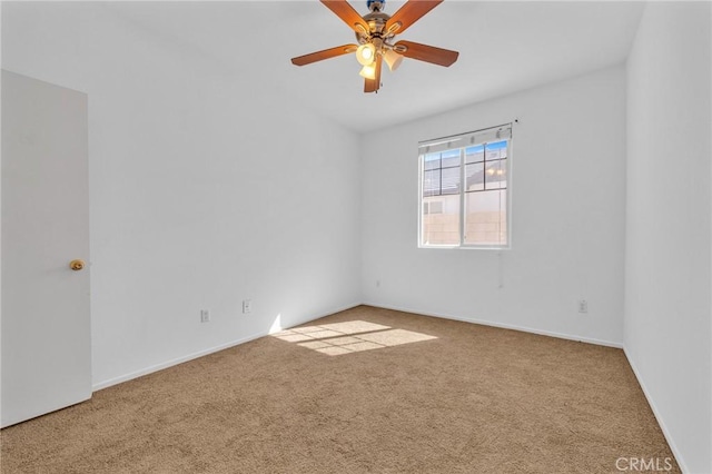 carpeted spare room featuring ceiling fan