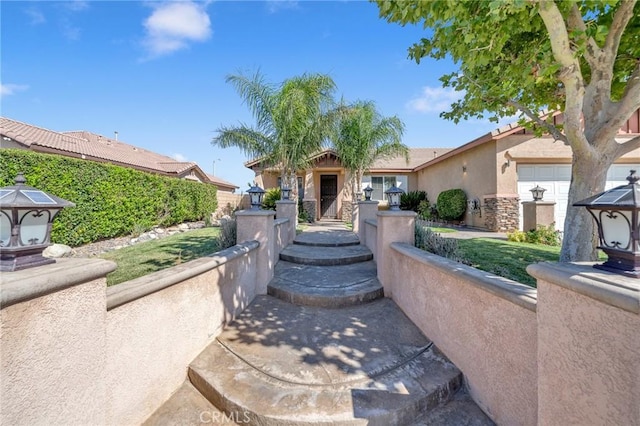 view of front of property featuring stone siding and stucco siding