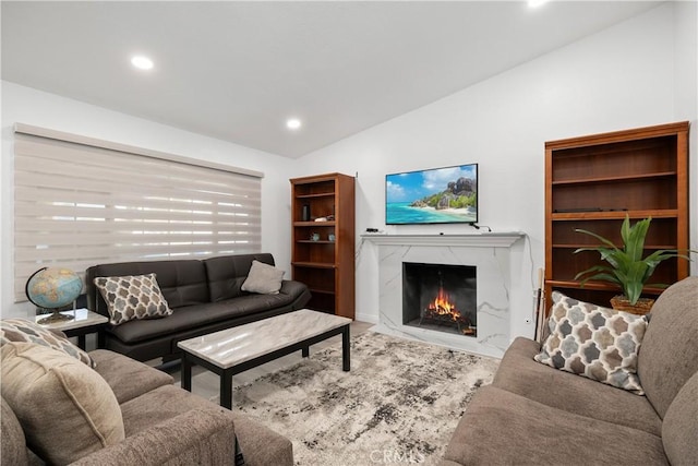 living room with a fireplace and vaulted ceiling