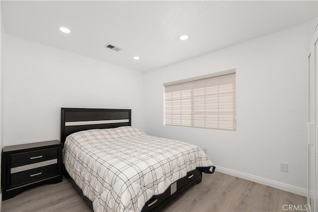 bedroom with hardwood / wood-style flooring