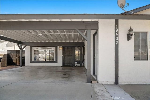 entrance to property featuring a carport