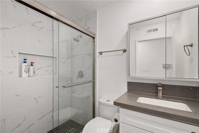 bathroom with vanity, toilet, and walk in shower