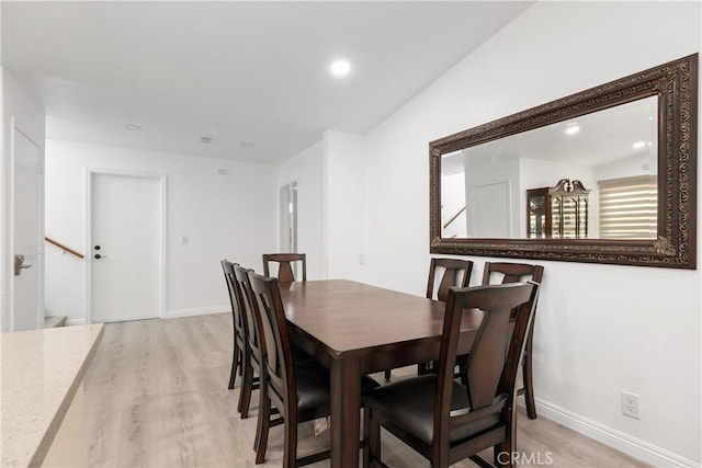 dining space with light hardwood / wood-style floors