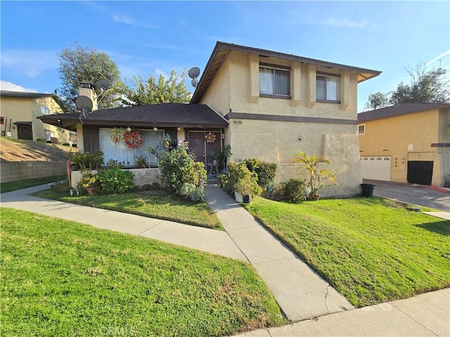 view of front of home with a front yard and a garage