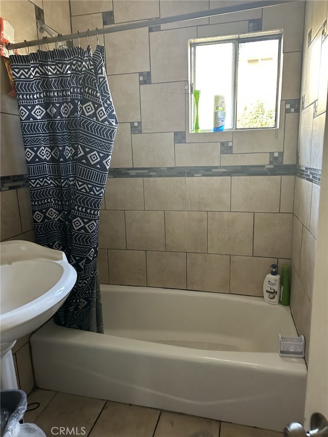 bathroom with tile patterned floors and shower / bath combo with shower curtain