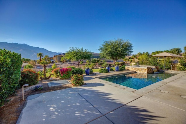 view of swimming pool featuring a mountain view and a patio area