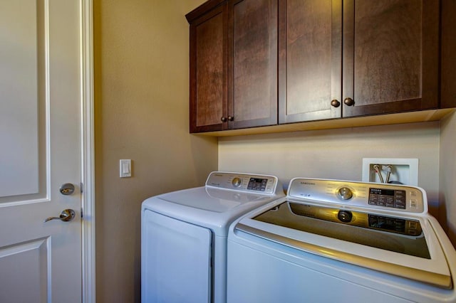 washroom with cabinets and independent washer and dryer