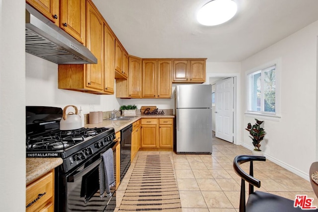 kitchen featuring light tile patterned floors, sink, and black appliances