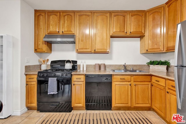 kitchen featuring sink, light tile patterned flooring, and black appliances