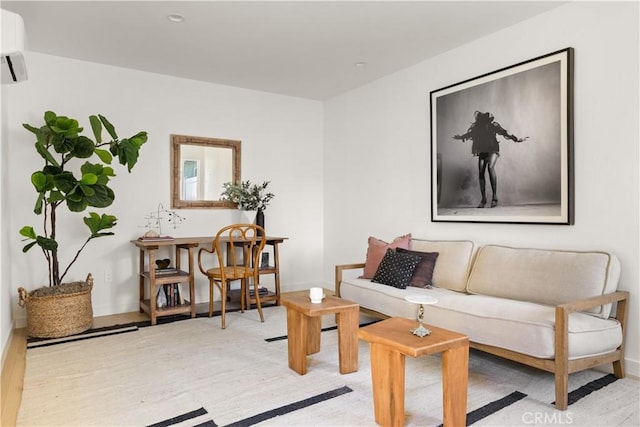 living room featuring light wood-type flooring and a wall mounted AC