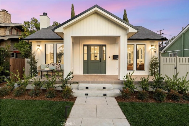 exterior space featuring a porch and a yard