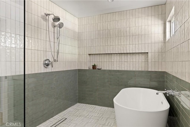 bathroom with separate shower and tub and tile walls