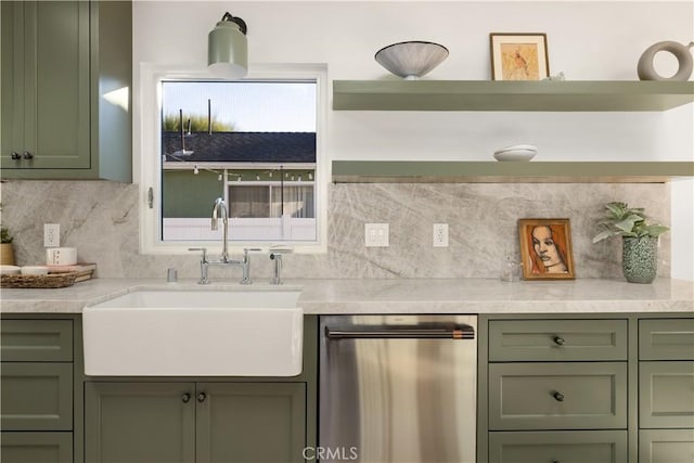 kitchen with light stone countertops, stainless steel dishwasher, green cabinetry, and sink