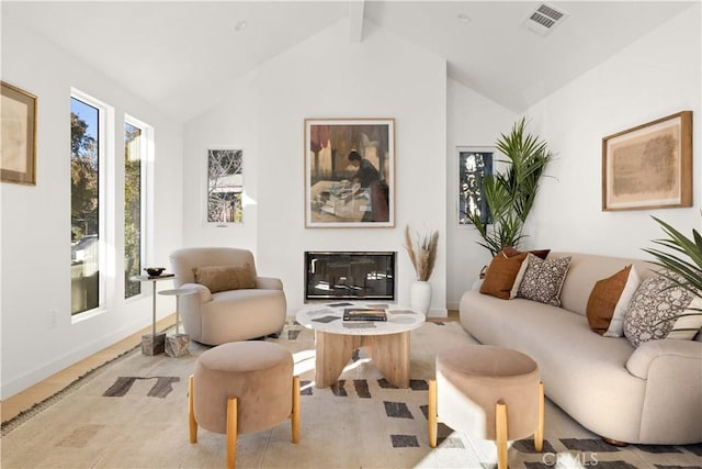 living room with lofted ceiling with beams