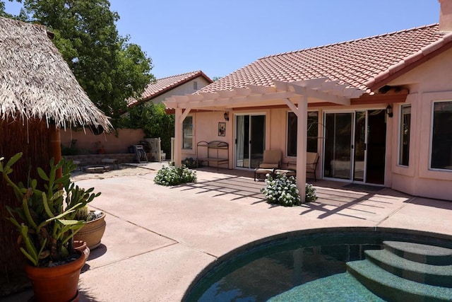 back of house with a pergola and a patio area