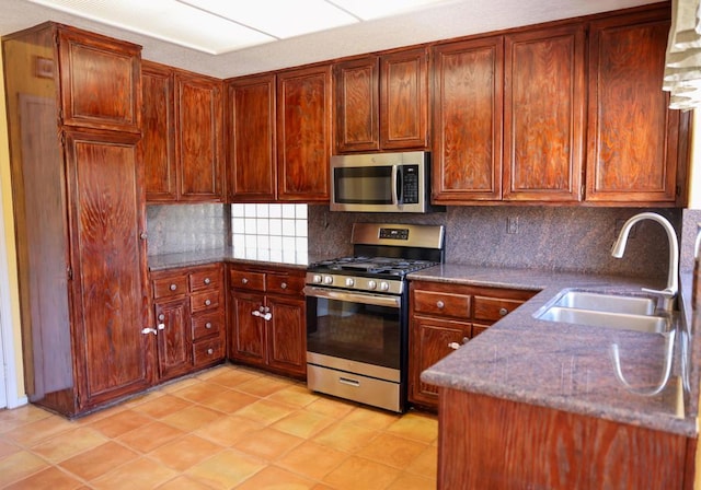 kitchen with tasteful backsplash, stainless steel appliances, and sink