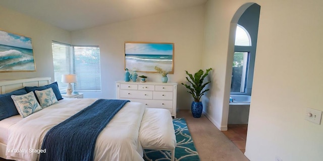 bedroom featuring lofted ceiling and light tile patterned floors