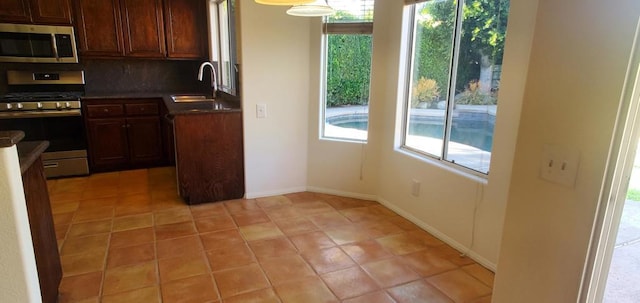 kitchen with stainless steel appliances, sink, decorative backsplash, and plenty of natural light