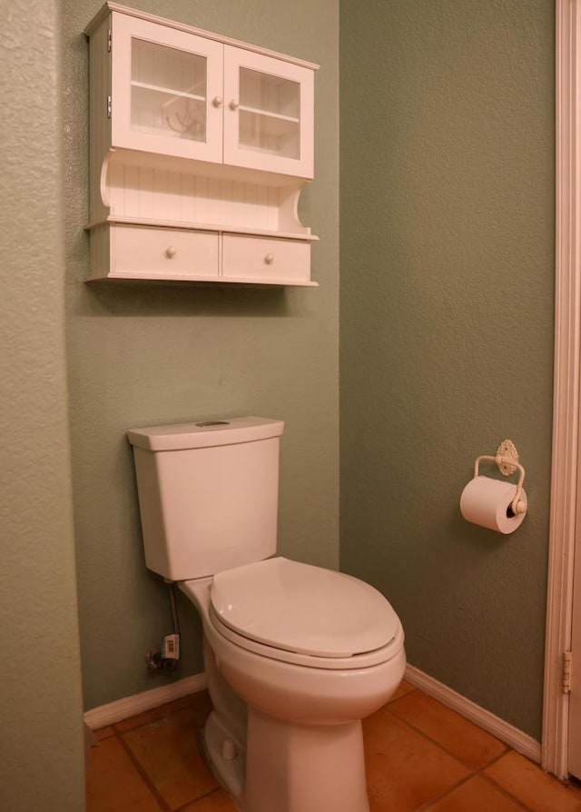 bathroom with tile patterned flooring and toilet