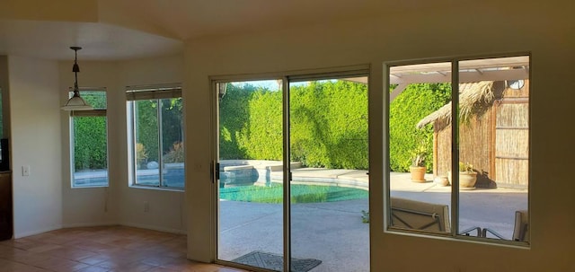 doorway to outside featuring tile patterned flooring and a healthy amount of sunlight