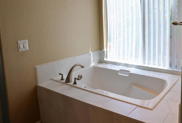 bathroom with tiled bath