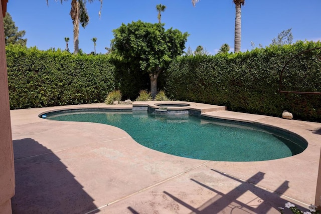 view of swimming pool featuring an in ground hot tub and a patio area