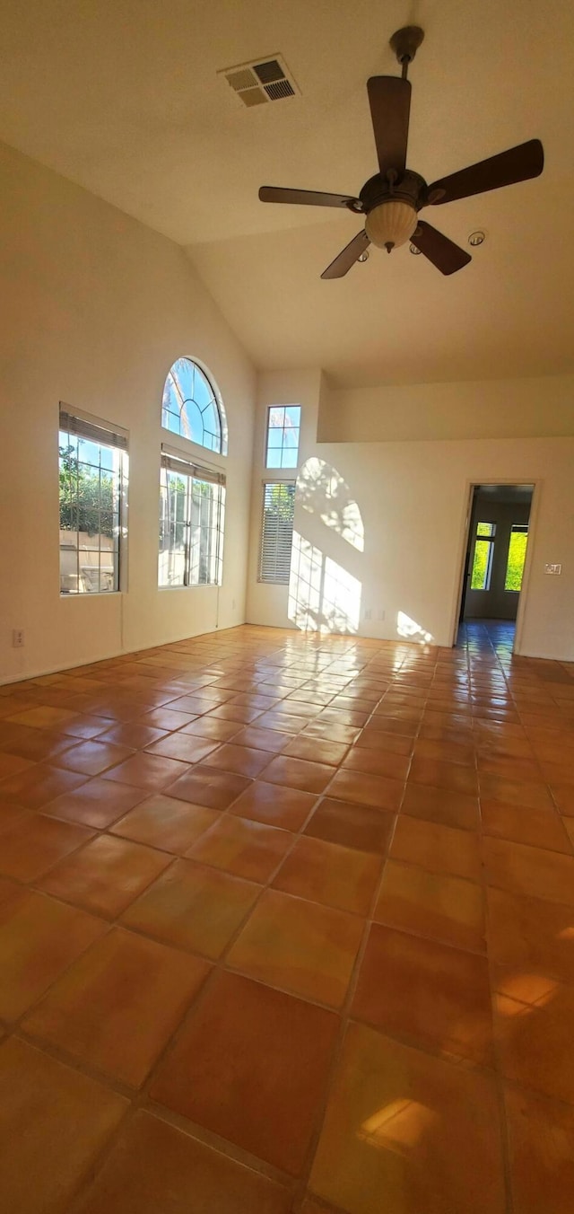 unfurnished room featuring lofted ceiling, tile patterned floors, and ceiling fan