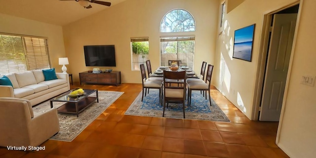 tiled dining room with a wealth of natural light, high vaulted ceiling, and ceiling fan