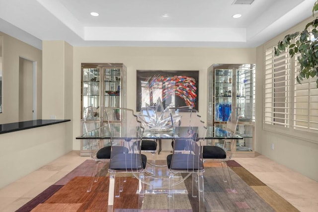 living area with a raised ceiling