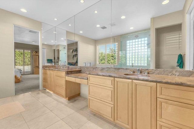 bathroom with a wealth of natural light, an enclosed shower, vanity, and tile patterned flooring