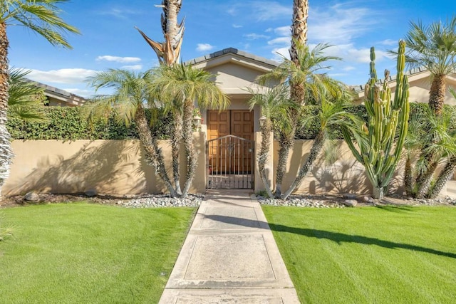 entrance to property featuring a lawn