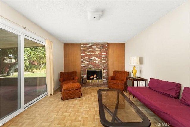 living room with light parquet floors and a fireplace